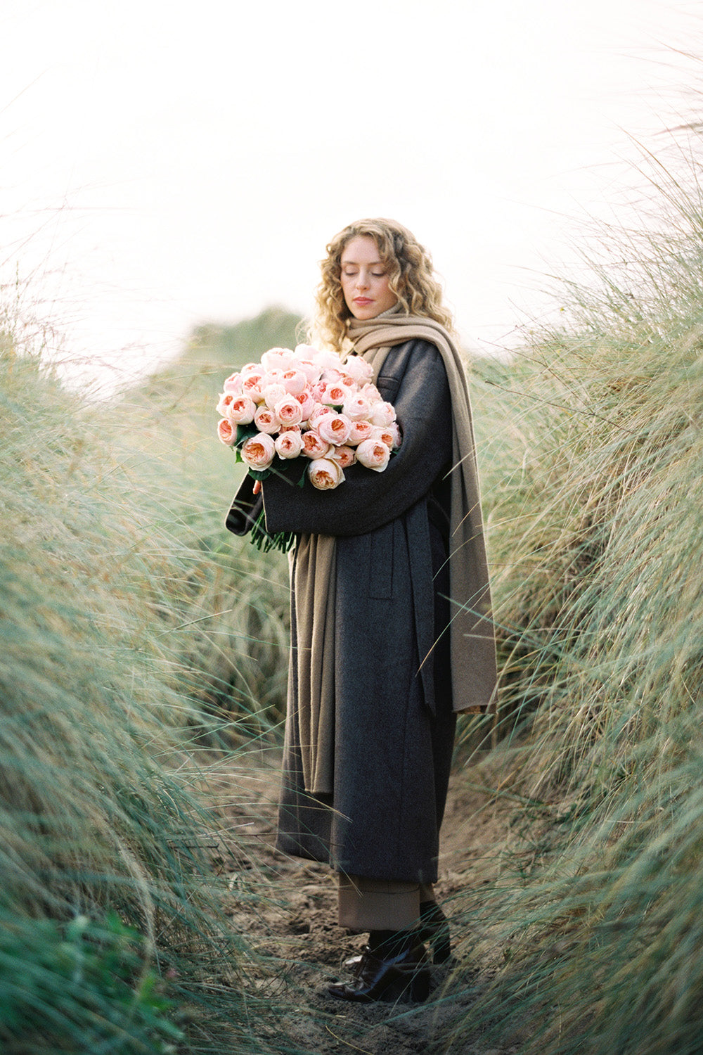 Juliet Muse Holding Large Bouquet in Sand Dunes