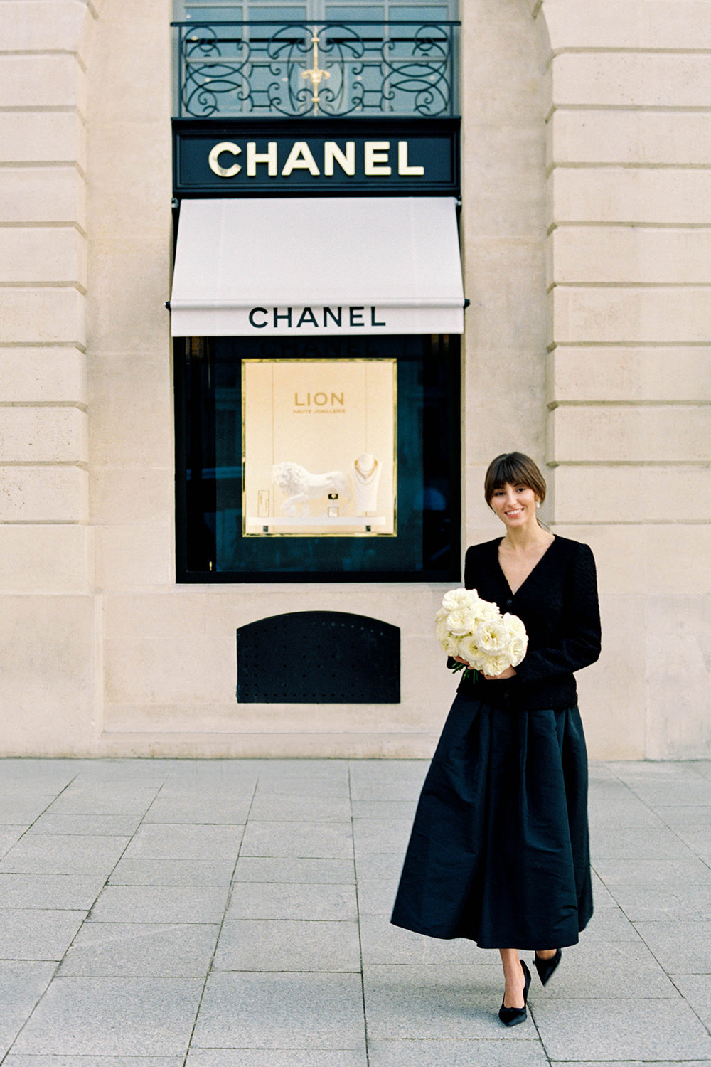 Leonora Rose Muse Holding Bouquet Outside Chanel Store in Paris