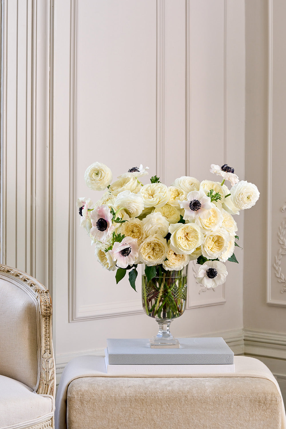 Tailored White Rose Bouquet Arrangement in Vase sat on Book