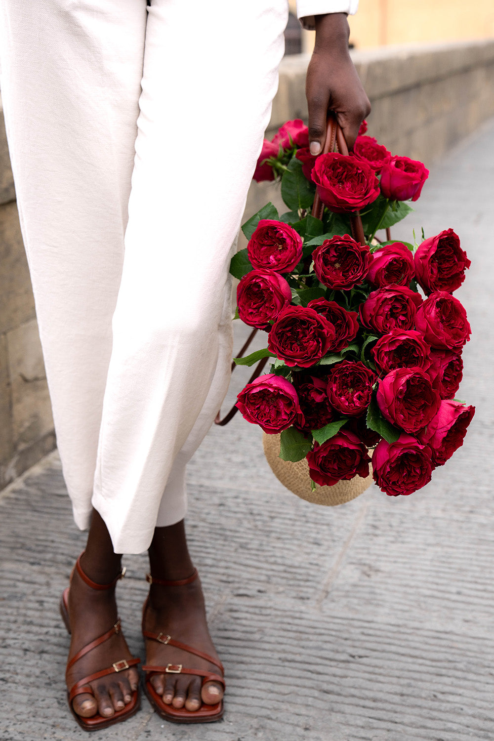 Tess Rose Muse Holding Bag of Roses