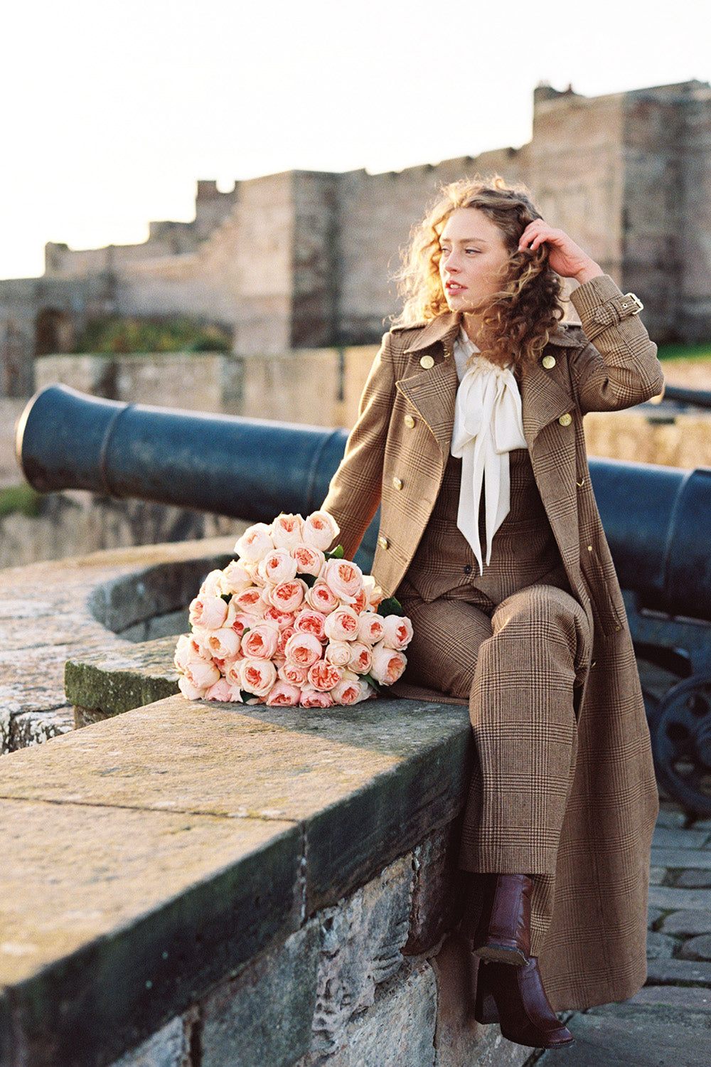 Juliet Muse Sat Outside Castle on Wall with Oversized Bouquet